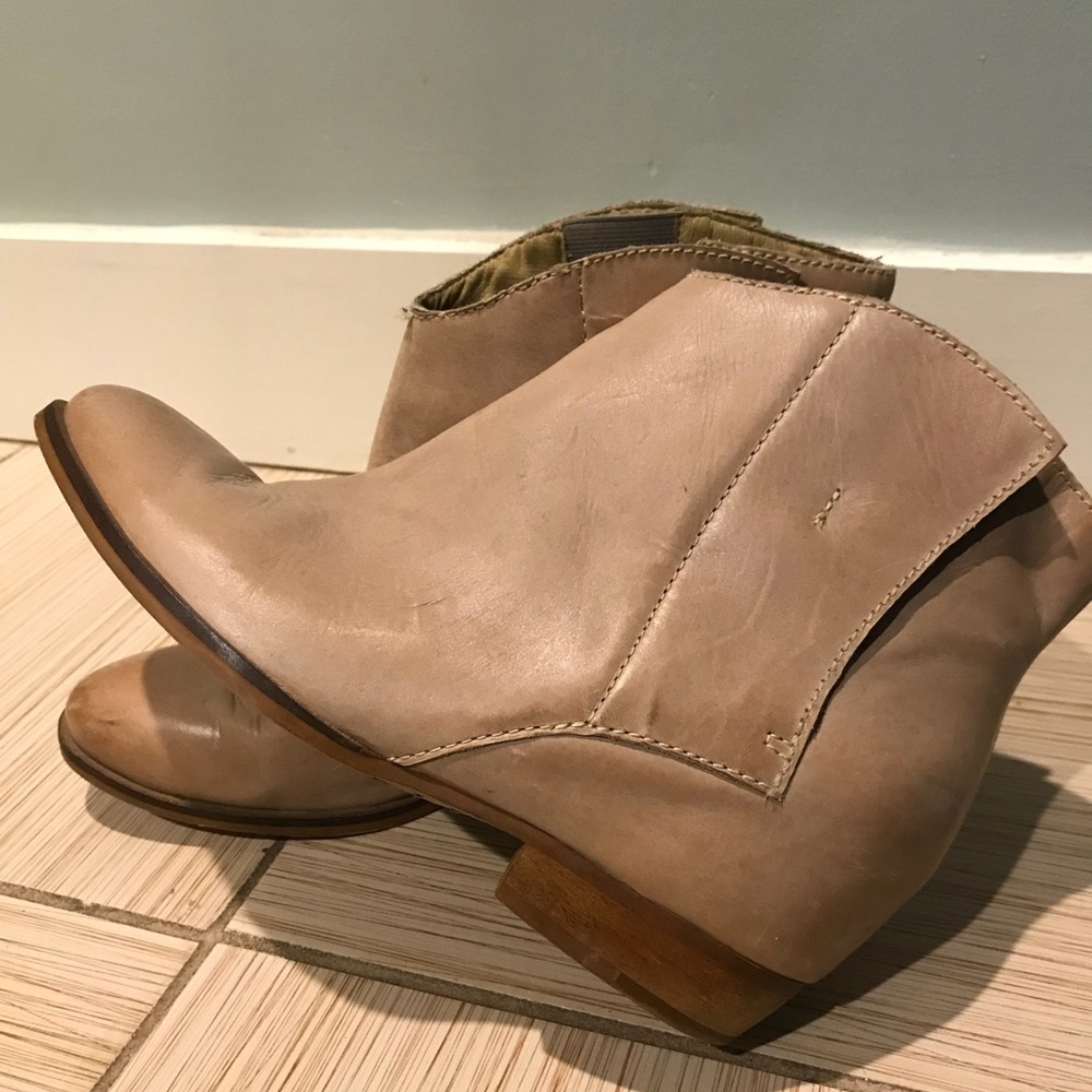 Tan leather booties with a hidden wedge heel.